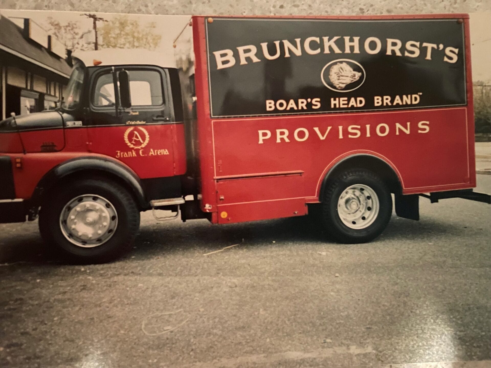 Vintage photograph showing the first truck used by the business with the signage: Brunckhorst's Provisions Boar's Head Brand