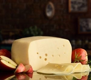 cheese supplier Jacksonville - Boar's Head Baby Swiss cheese wheel with characteristic holes, offered by a cheese supplier in