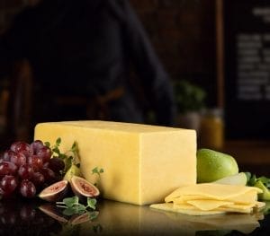 Boar's Head Irish Cheddar Cheese block on a wooden board
